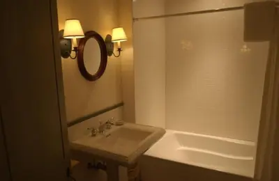 a bathroom with a sink and a tub and a mirror at The Old Inn On The Green in New Marlborough