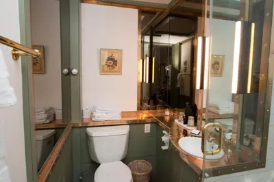 a bathroom with a sink and a toilet and a mirror at The Old Inn On The Green in New Marlborough
