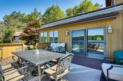 a patio with a table and chairs on a deck at Waterfront Home on White Lake Near Bethel Woods! in White Lake
