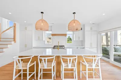 a kitchen with a large white island with bar stools at Stareway to Heaven in Fairfield
