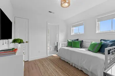 a white bedroom with a bed and a flat screen tv at Stareway to Heaven in Fairfield