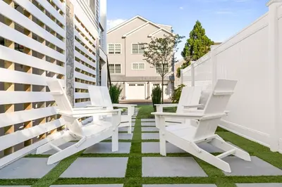 a patio with white chairs and a fence at Stareway to Heaven in Fairfield