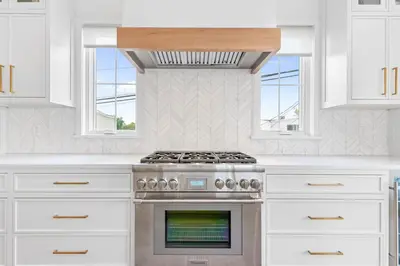 a kitchen with a stove and two windows at Stareway to Heaven in Fairfield