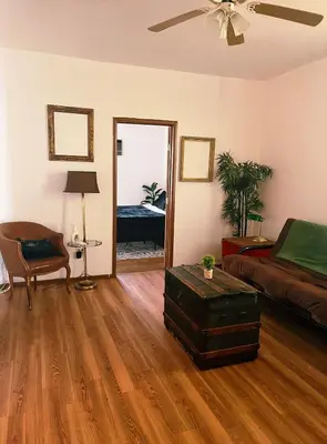 a living room with a bed and a couch at Ironbound 4 bdrm Industrial Suite! FREE parking in Newark
