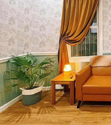 a living room with a couch and a plant at 3 bdrm stay! Trippy King Suite by Dwtwn Nwk in Newark