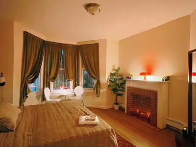 a bedroom with a bed and a fire place at 3 bdrm stay! Trippy King Suite by Dwtwn Nwk in Newark