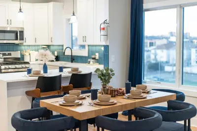 a kitchen with a table and chairs and a kitchen with a view at Free Parkng 2br 2ba 2 King beds EWR 15min in East Newark