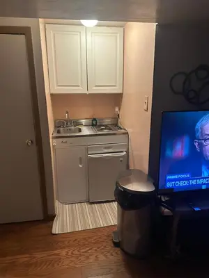 a small kitchen with a sink and a laptop computer at Your Home away from Home ! in Baychester
