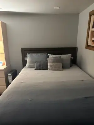 a bed with two pillows on it in a bedroom at Your Home away from Home ! in Baychester