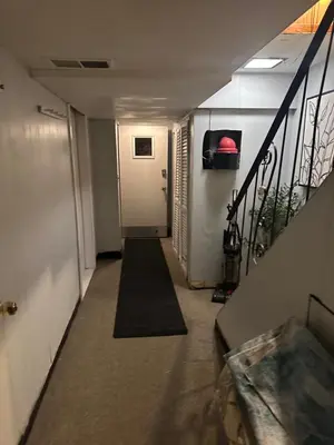 a hallway with a door and a stairway at Your Home away from Home ! in Baychester