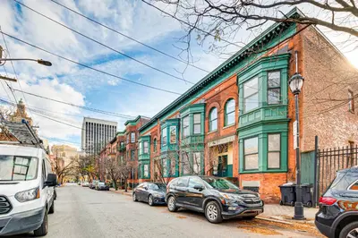 a street with cars parked in front of buildings at 1 Mi to Prudential Center Remote Work-Ready Apt in Newark