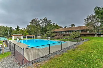 a fence around a swimming pool in a yard at 1 floor, Pocono Pond house with Game Room in Tobyhanna