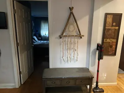 a hallway with a bench in a room at Your Home away from Home ! UNIT 2- 1st floor in Baychester
