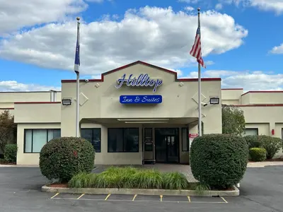 a building with two flags in front of it at Hilltop Inn & Suites in Yonkers