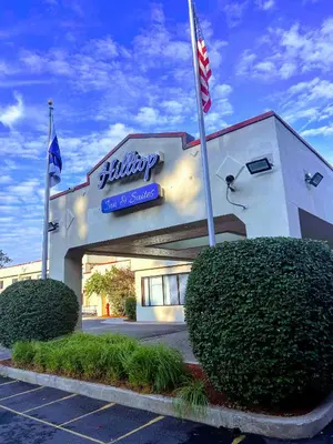 a building with two flags in front of it at Hilltop Inn & Suites in Yonkers