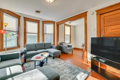 a living room with a large flat screen tv at Walk to Washington Park Remote Work-Ready Apt! in Albany