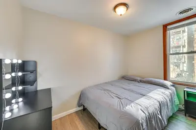 a bedroom with a bed and a desk and a window at Walk to Washington Park Remote Work-Ready Apt! in Albany