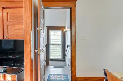 a hallway with a door open to a kitchen at Walk to Washington Park Remote Work-Ready Apt! in Albany