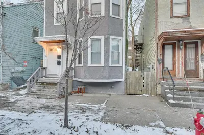 a house with a red fire hydrant in front of it at Walk to Washington Park Remote Work-Ready Apt! in Albany