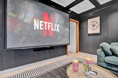 a living room with a large screen with netflix at Lakefront Movie Theater, Hot Tub, Arcade, Boats in Gouldsboro