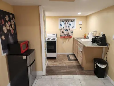 a kitchen with a black refrigerator and a microwave at 2kings Apartment in Newark