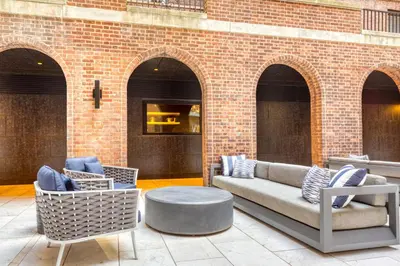 a patio with a couch and chairs and a table at Blueground Boerum Hill gym wd nr sports NYC-1573 in New York