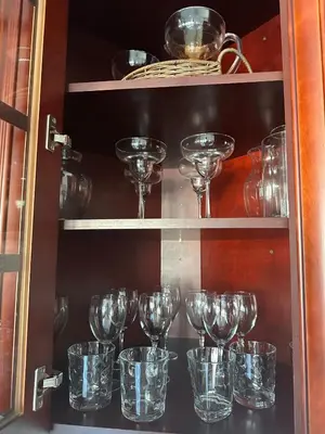 a bunch of glass wine glasses in a cabinet at Skyline Penthouse in Woodside
