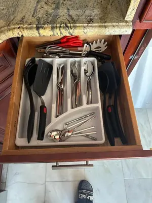 a drawer filled with utensils in a wooden box at Skyline Penthouse in Woodside