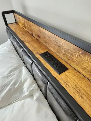 a close up of a bed with a wooden headboard at Elegant Retreat Where Relaxation Embraces Design in Springfield