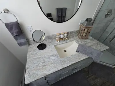 a bathroom with a sink and a mirror at The Jefferson Guest House in Litchfield
