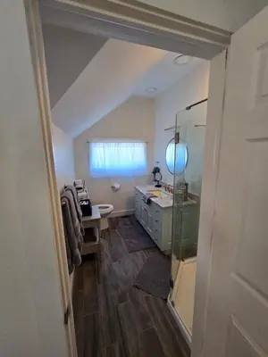 a bathroom with a sink and a toilet and a mirror at The Jefferson Guest House in Litchfield
