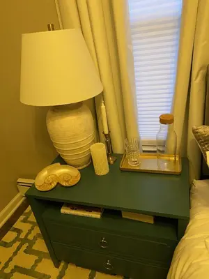 a table with a lamp on top of a bed at Wooster Square Gems in New Haven
