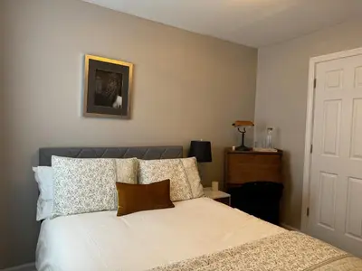 a bedroom with a bed with white sheets and pillows at Wooster Square Gems in New Haven