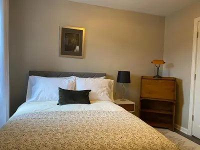 a bedroom with a bed with a black pillow on it at Wooster Square Gems in New Haven