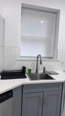 a kitchen counter with a sink and a window at Private Bedroom with Dedicated Bathroom 15mis NYC in West New York