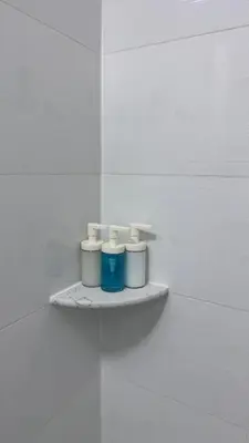 a shelf with three candles on a white wall at Private Bedroom with Dedicated Bathroom 15mis NYC in West New York