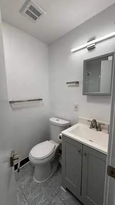 a white bathroom with a toilet and a sink at Private Bedroom with Dedicated Bathroom 15mis NYC in West New York