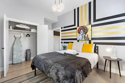 a bedroom with a large bed with striped walls at 1A Prime Area Near NYC and EWR 98 Walk score in Newark