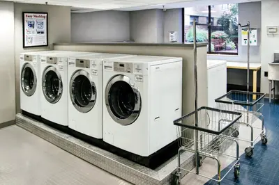 a row of white washing machines in a store at UWS 1br w gym doorman elevator nr Central Park NYC-1049 in New York