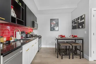 a kitchen with a counter and a table with chairs at 2C - Parking Cred, Early CI, King Bed, Sleeps 6 - 30mins to NYC in Newark