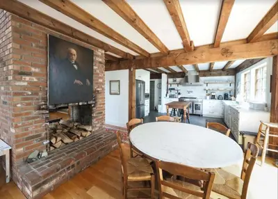 a living room with a brick fireplace and a table at Charming 6 Bdrm Countryside Stay, Sauna and HotTub in North Egremont