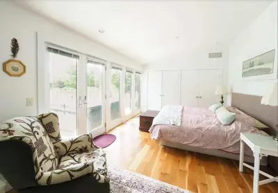 a bedroom with a bed and a couch and a chair at Charming 6 Bdrm Countryside Stay, Sauna and HotTub in North Egremont