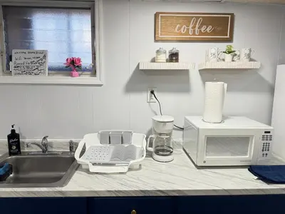 a kitchen counter with a microwave and a sink at Cozy 1 bedroom close to NYC with private bar in North Bergen