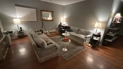 a living room with two couches and a table at Cozy Brooklyn Home, Private Room in Host Shared Apartment in Brooklyn