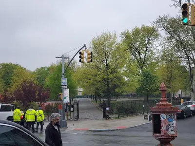 a man crossing a street with a traffic light at Cozy Brooklyn Home, Private Room in Host Shared Apartment in Brooklyn