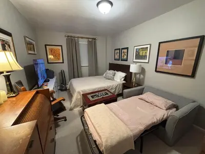 a hospital room with two beds and a desk at Cozy Brooklyn Home, Private Room in Host Shared Apartment in Brooklyn