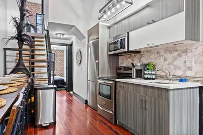 a kitchen with a sink and a counter top at Rustic Chic 4BR for Groups - Bushwick's Finest Stay in Brooklyn