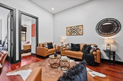 a living room with two couches and a mirror at Rustic Chic 4BR for Groups - Bushwick's Finest Stay in Brooklyn