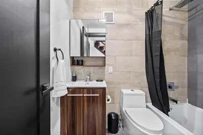a bathroom with a sink and a toilet and a tub at Rustic Chic 4BR for Groups - Bushwick's Finest Stay in Brooklyn
