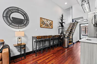 a group of bar stools in a living room at Rustic Chic 4BR for Groups - Bushwick's Finest Stay in Brooklyn